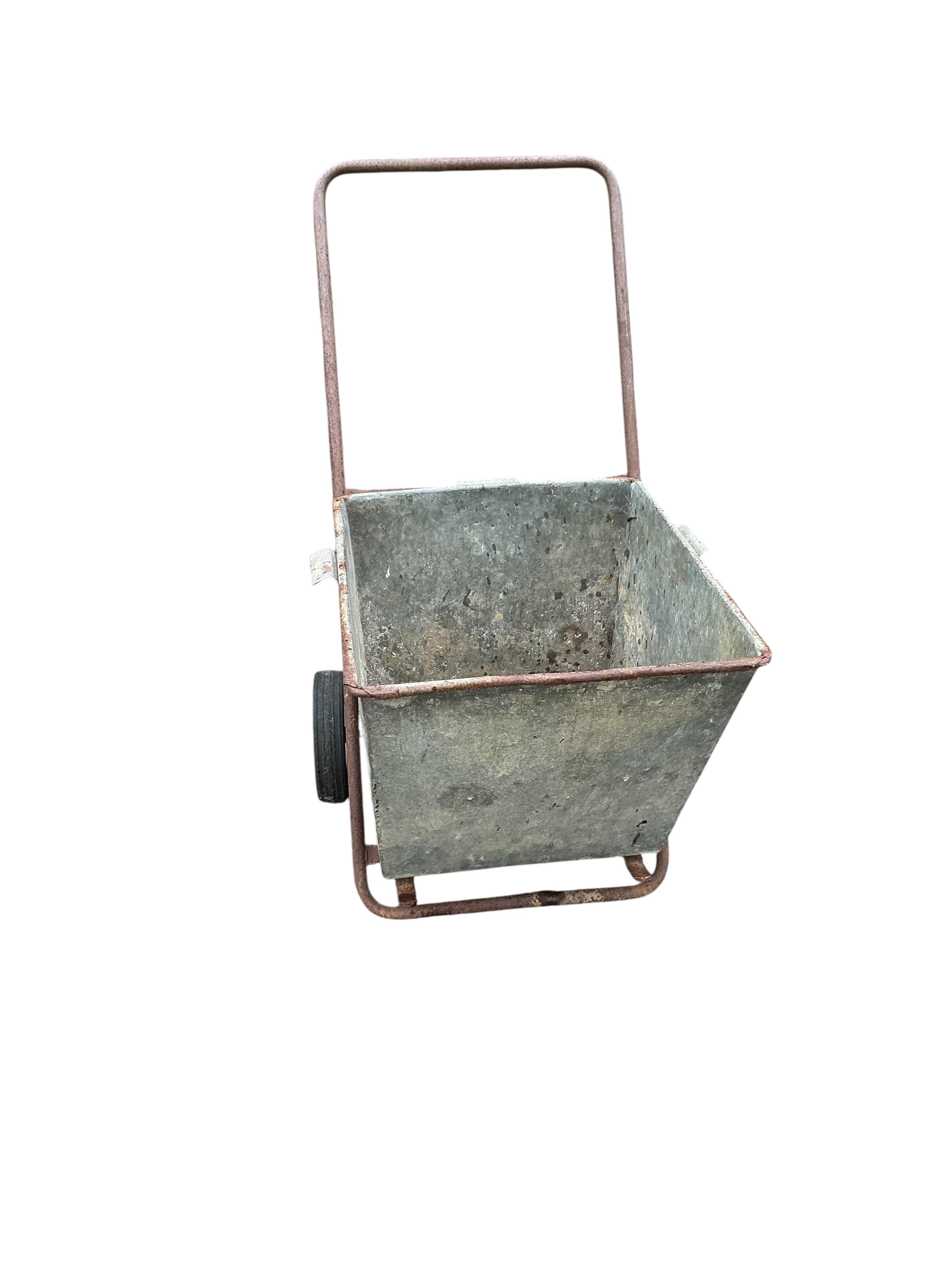 A vintage galvanised garden wheelbarrow, height 91cm